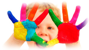 A child with their hands painted in rainbow colors.